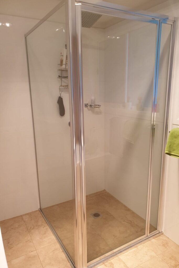 Framed shower glass installation in a bathroom