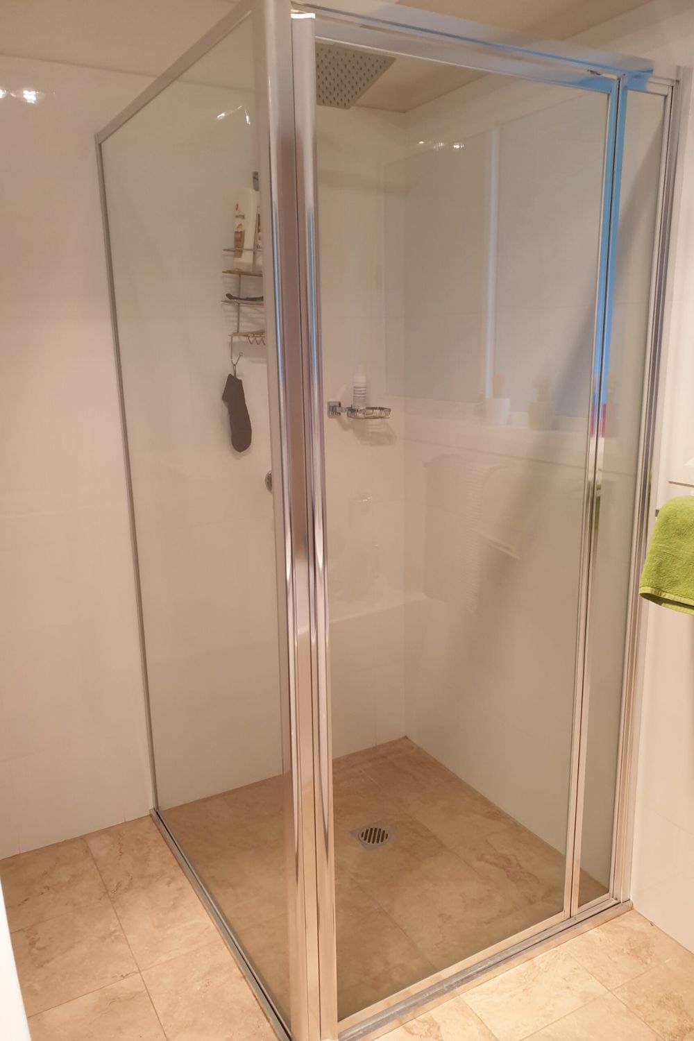 Framed shower glass installation in a bathroom