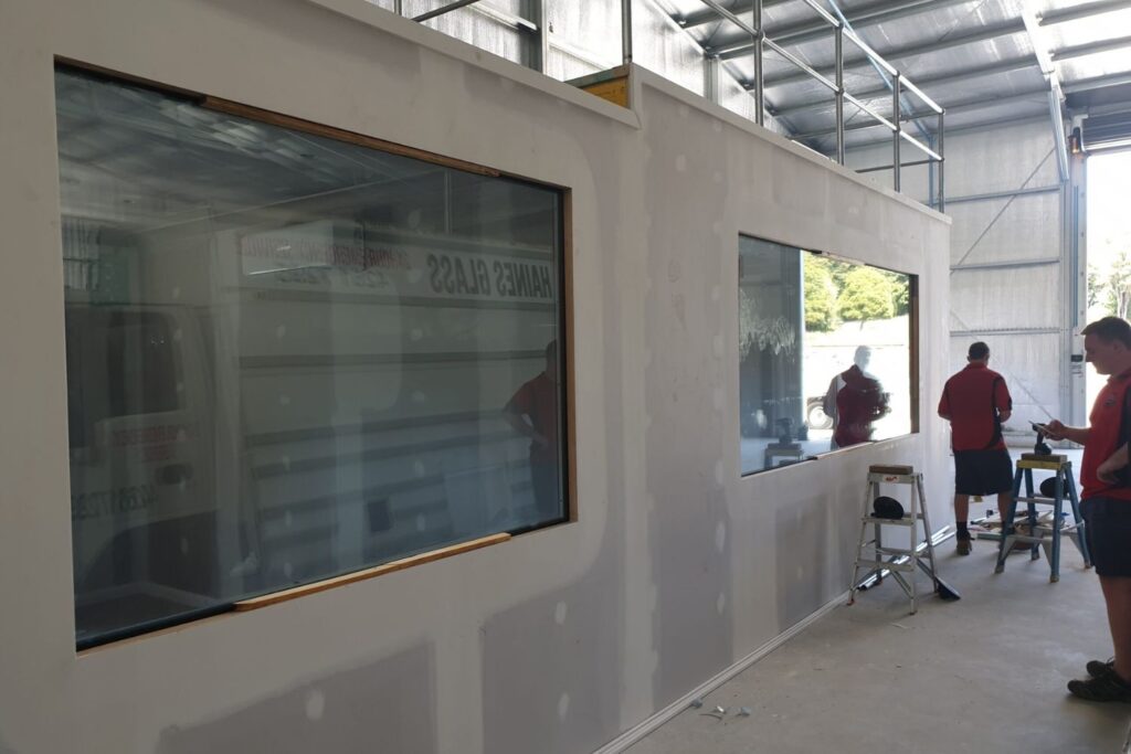 Qualified glaziers installing large windows