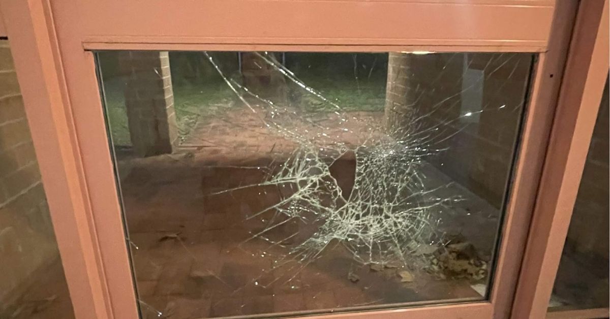 Cracked window glass with large impact spiderweb pattern