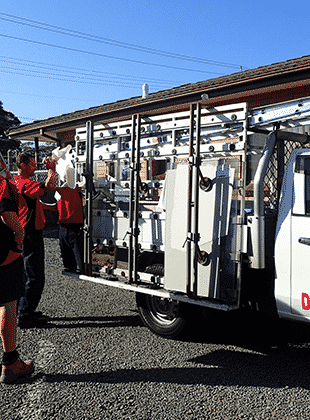 A Haines Glass worker loading his ute outside the workshop in Dapto